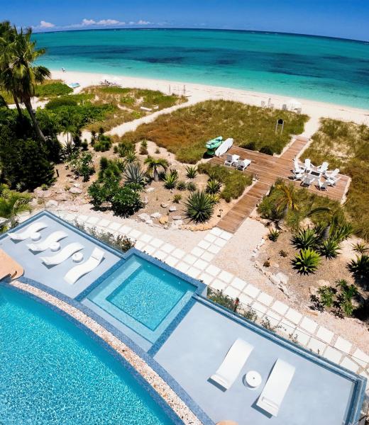 Wake up to the sound of the ocean, step directly onto soft white sand, and spend your days moving effortlessly between the beach, private infinity-edge pool, and shaded outdoor living spaces. Whether you’re enjoying coffee at sunrise, lounging poolside, or unwinding by the firepit at sunset, this home is designed for unforgettable moments....